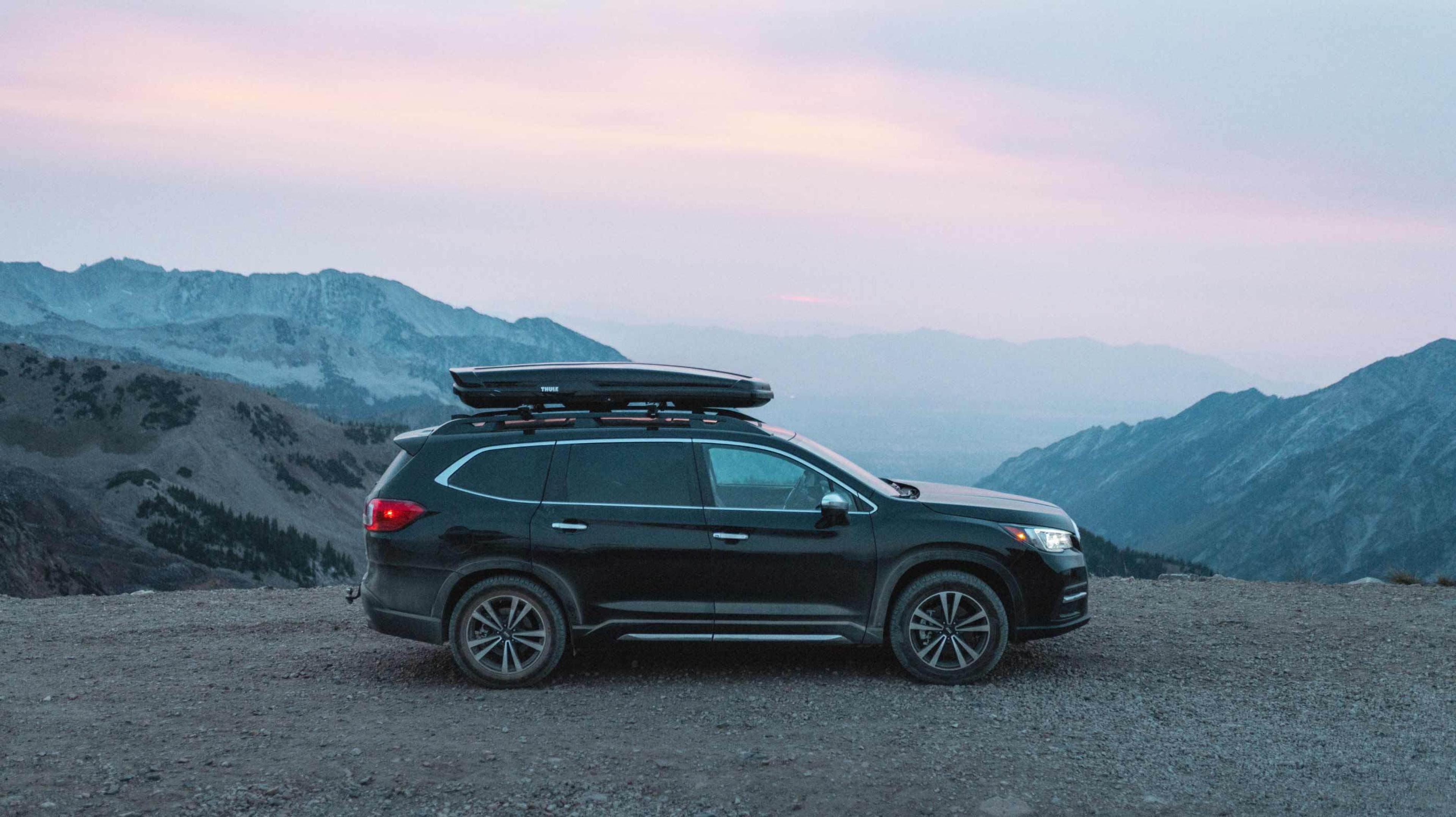 Black SUV equipped with Nokian One tires sitting on the top of a mountain